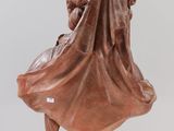 a brown marble bust of a man with a veil on his head