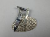 a small metal object with a knife on top of it