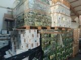 a large amount of boxes stacked on pallets in a warehouse