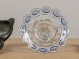 three pieces of glass sitting on a table next to each other