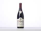 a bottle of red wine sitting on top of a table