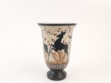 a black and white vase with a picture of a deer on it