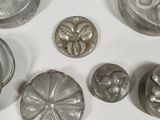 a lot of silver objects sitting on a table