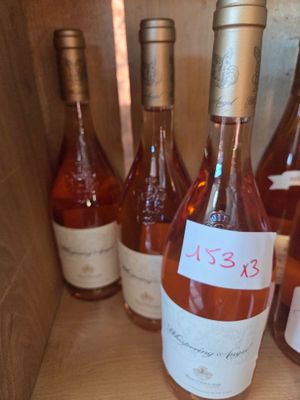 several bottles of wine are lined up in a wooden box