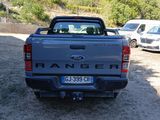 a truck that is parked in a lot with other cars