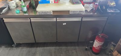 a picture of a kitchen with a lot of clutter on the counter