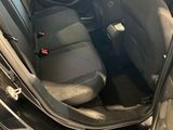 the interior of a car with the door open and the seat up