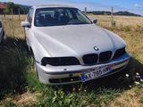 two cars are parked in a field with a fence in the background