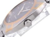a close up of a watch on a white surface