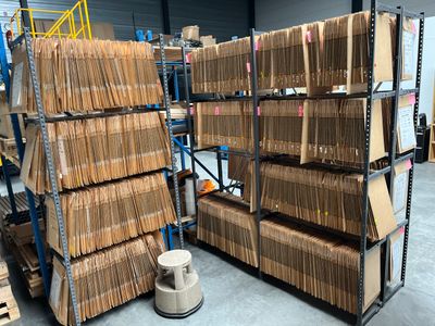 a large amount of boxes stacked on a rack in a warehouse