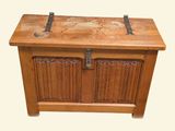 a wooden chest with a metal latch on top of it
