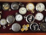 many different types of pocket watches in a box