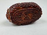 a close up of a carved object on a white surface