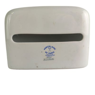 a white paper towel dispenser on a white surface