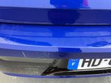 a close up of a blue car with a blue license plate on it