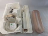 a plastic container with a toothbrush and other items in it