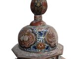 a blue and red vase with a lid on a white background