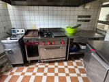 a kitchen with a stove, oven, and sink in it