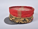 a red hat with gold trim on top of a coin