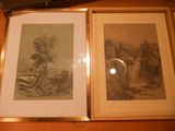 two framed pictures on a table next to each other