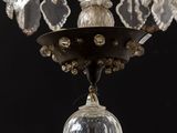 a chandelier with a glass ball hanging from it ' s ceiling