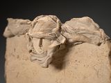 a sculpture of a man and a woman on a stone block