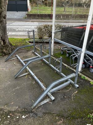 a metal bench that has been placed on the side of the road