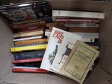 une boîte remplie de livres posés sur le sol