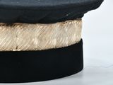 a black hat with a gold band around it