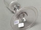 two wine glasses sitting on a table with labels on them