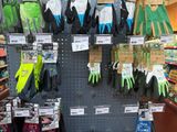 display of gardening gloves for sale in a store with price tags