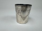 a silver cup that has a heart on it