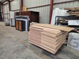 many stacks of wood in a warehouse with a lot of boxes