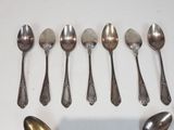 six spoons that are lined up together on a table