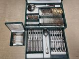 a green case with silverware in it on a table