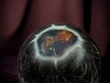 a glass ball with a picture on it sitting on a table