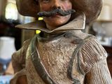 a figurine of a man with a hat and a moustache