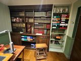 an image of a home office with a desk and bookshelf