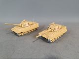 two toy tanks sitting side by side on a table
