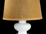 a white table lamp with a brown shade on it