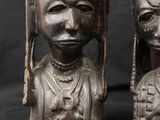 pair of african carved wooden head statues of a woman and a man