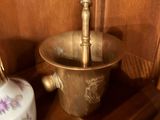 a vase and a bowl on a shelf in a room