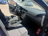 the interior of a car with the door open and the driver ' s seat down