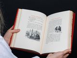 someone is reading a book with a picture of a man and a woman on it