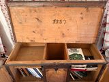 an old wooden chest with a book on it