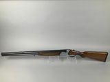 a shotgun with a wooden barrel and a wooden handle