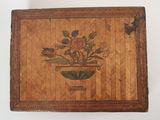 a wooden box with a painting of flowers on it