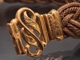 a close up of a gold belt on display