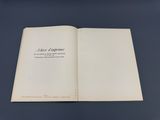 an open book on a table with a black background