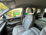 l'intérieur d'une voiture comportant deux rangées de sièges et un téléviseur à l'arrière